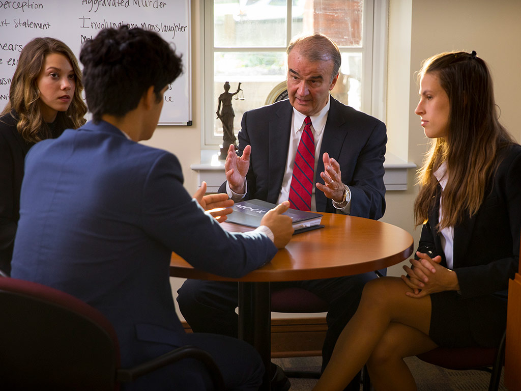 professor is discussing with students