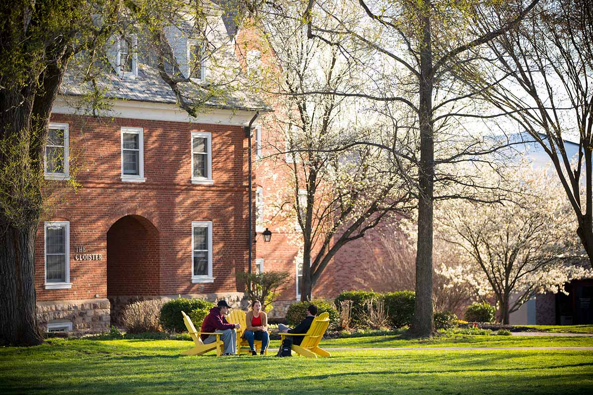 photo of students sitting in chairs on the campus quad