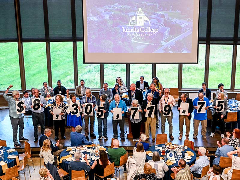 the class 0f 1975 celebrate while presenting the 50th reunion gift